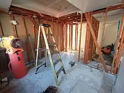 Removal of dry wall and building insulation from the walls, removal of the old ceiling light installation