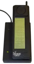 1994 IBM Simon on charger, an early smartphone.