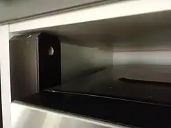 A support bracket's top; notice the screw hole in the bevel: here, the frame will be attached.