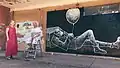 Гамлет Зиньковский в процессе создания стрит-арта в городе Бердянск. Работа находится на улице Шевченко, 8