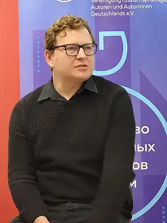 Даниил Бендицкий на чтениях Содружества русскоязычных литераторов Германии (СЛоГ) 9 декабря 2023 года в Берлине