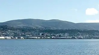 Флагстафф возвышается над центром Данидина. Фото сделано с восточного берега залива Отаго.