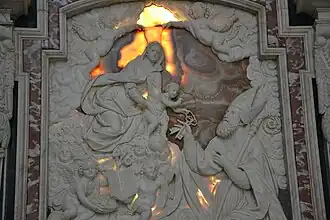 Madonna con Bambino e San Siro, rilievi di Tommaso Orsolino, 1653, Pavia, Cappella di San Siro nel Duomo. Il Bambin Gesù, in braccio alla Vergine, consegna a San Siro le chiavi della Città di Pavia.