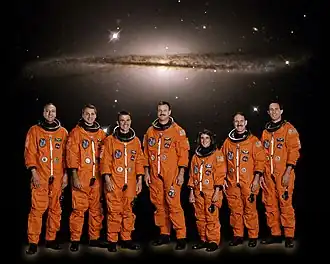 (слева-направо): Массимино, Линнехан, Д. Кэри, Олтман, Н. Кэрри, Грансфелд и Ньюман