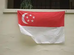 A home displaying the national flag underneath their window