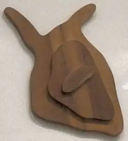 Arp, 1943: 'Impish Fruit', wood (walnut) relief]]