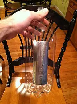 Step 2: Cut 5.5 " strips of aluminum tape and stuck them to the middle bottle.